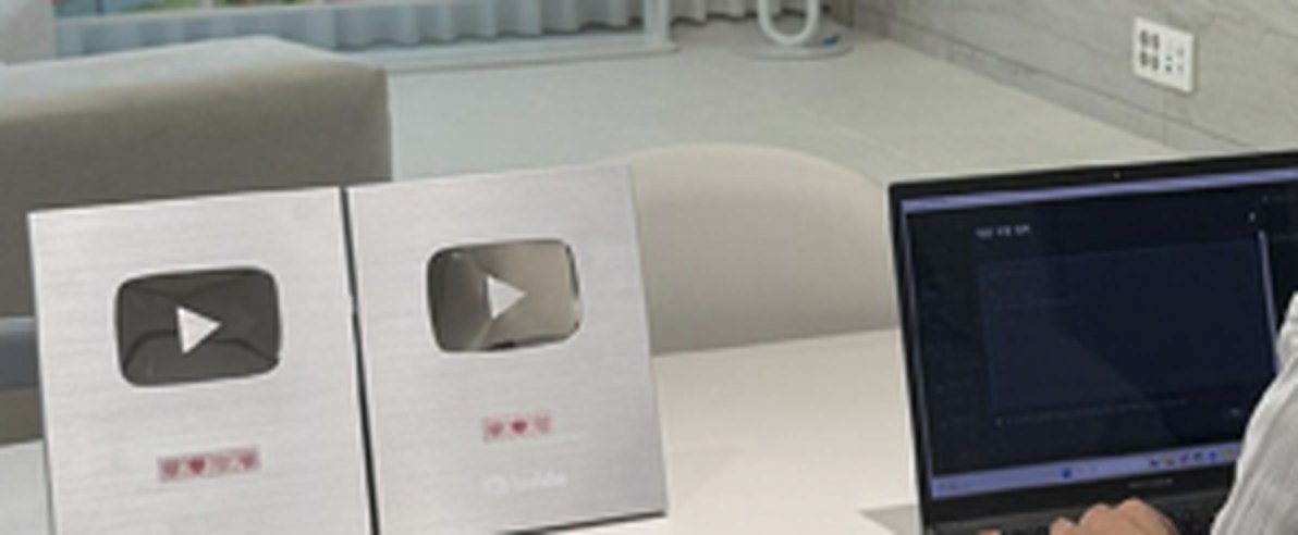 책상 위 실버버튼 두 개와 프로그램이 켜진 노트북